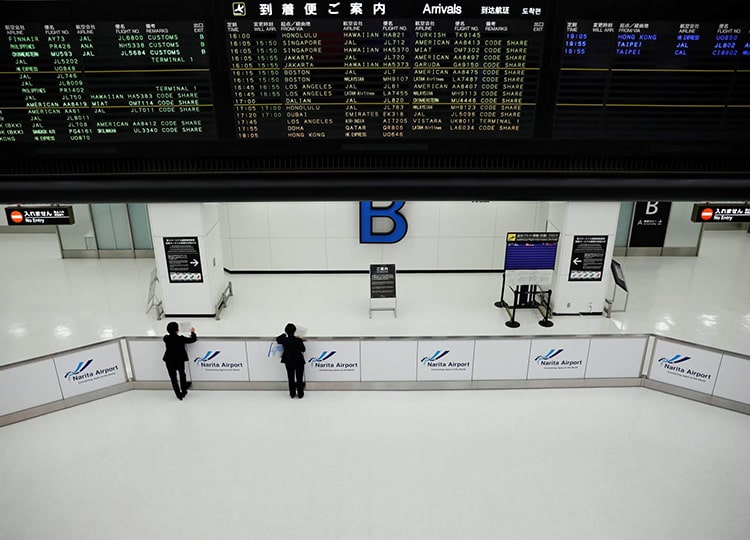 Staffers wait for passengers at an arrival hall at Narita Airport in Chiba Prefecture on Nov. 30.