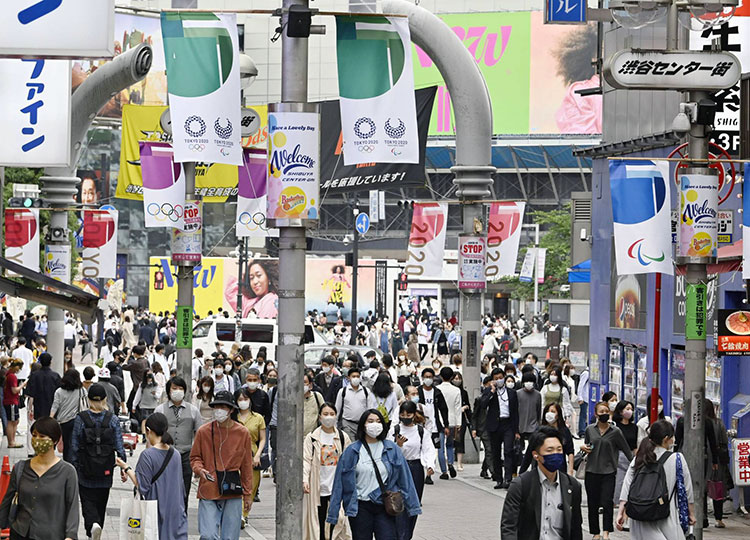 People walk in Tokyo’s Shibuya district on May 28.