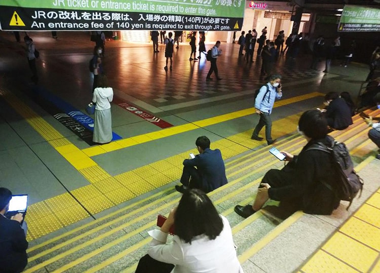 People wait at Shinagawa Station in Tokyo after trains were suspended on Oct. 7.