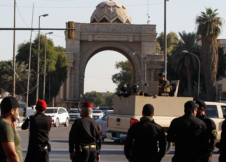 Iraqi security forces take part in a security deployment following the drone attack on the prime minister’s residence at one of the fortified Green Zone entrances in Baghdad on Nov. 7.