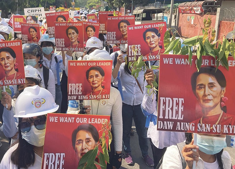 Protesters hold portraits of deposed Myanmar leader Aung San Suu Kyi during an anti-coup demonstration in Mandalay, Myanmar, on March 5.