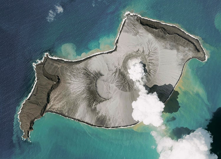 A handout photo made available by 2022 Planet Labs PBC on Jan. 17 shows an eruption of the Hunga Tonga-Hunga Ha’apai volcano, about 65 kilometers north of Tongatapu, Tonga’s main island, on Jan. 7, a week before a much larger eruption covered Tonga in ash.