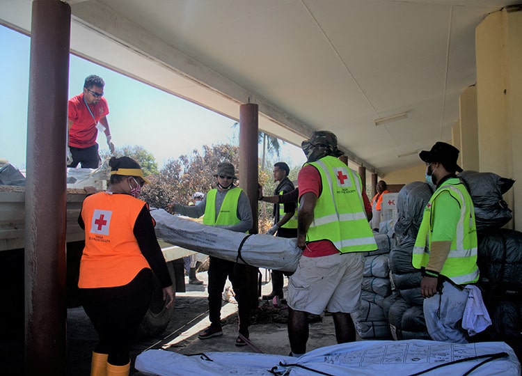 Members of Tonga’s Red Cross society engage in relief work in Kanokupolu, Tonga, on Jan. 23.
