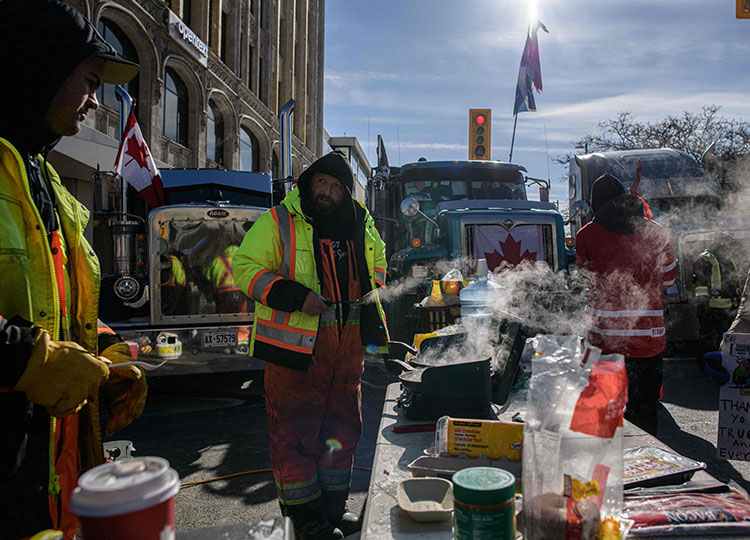 Demonstrators cook breakfast during a protest by truck drivers over pandemic health rules and the government outside the Canadian Parliament in Ottawa, Ontario, on Feb. 13.