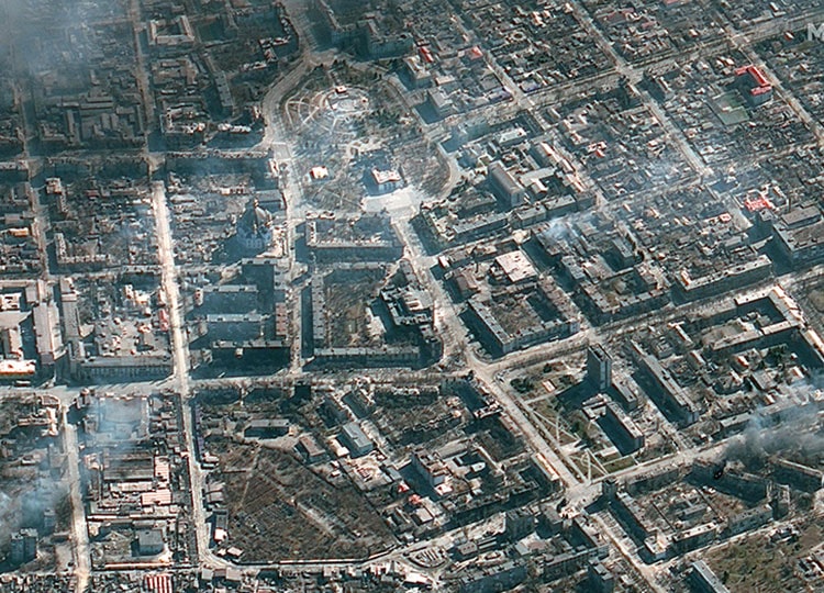 This Maxar satellite image taken and released March 21 shows an overview of burning buildings and the Mariupol theater in Mariupol, Ukraine.