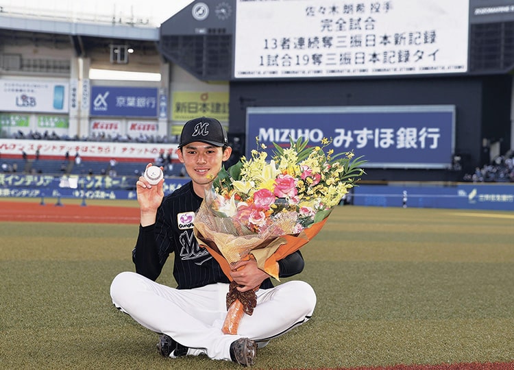 Lotte Marines pitcher Roki Sasaki poses for a photo after throwing a perfect game against the Buffaloes in Chiba on April 10.