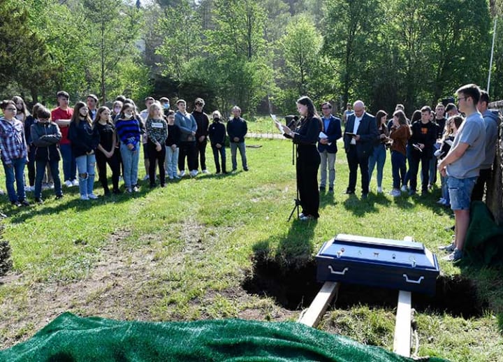 Peace at last: German students bury classroom skeleton after 70 years