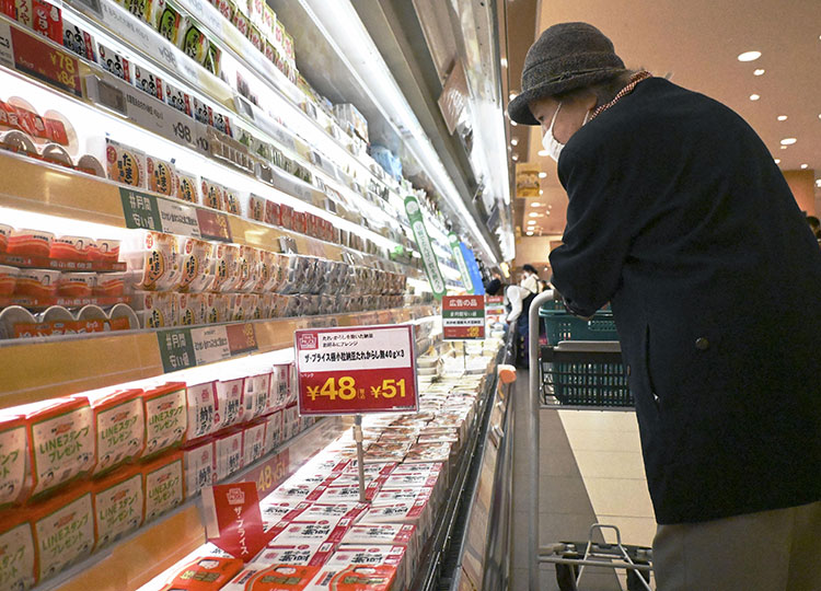 A shopper looks at products lining the shelves at a supermarket in Tokyo on May 2.