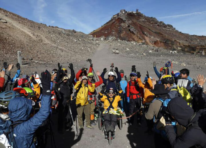 90-year-old alpinist reaches summit of Mount Fuji in wheelchair – with a little help